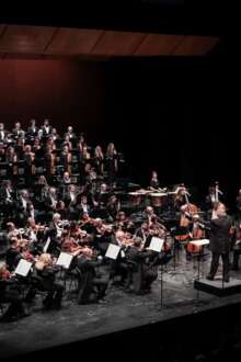 A orquestra sinfónica portuguesa e o coro do teatro nacional são carlos em palco.